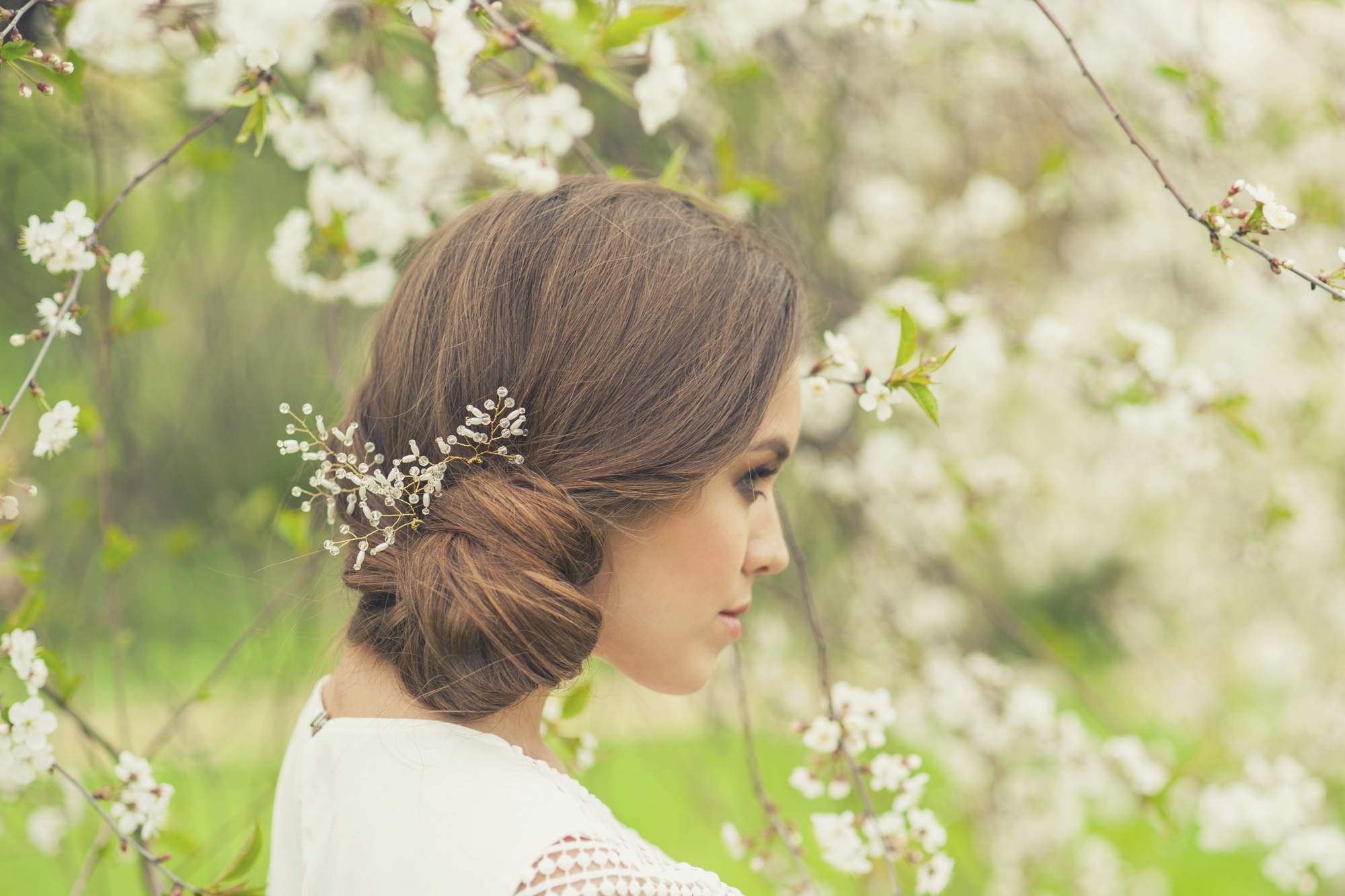 Bridemaids hair ideas include this side bun chignon finished with jewelled hair slide