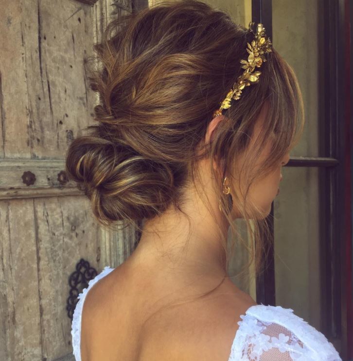 Brown hair in low bun with loose tendrils