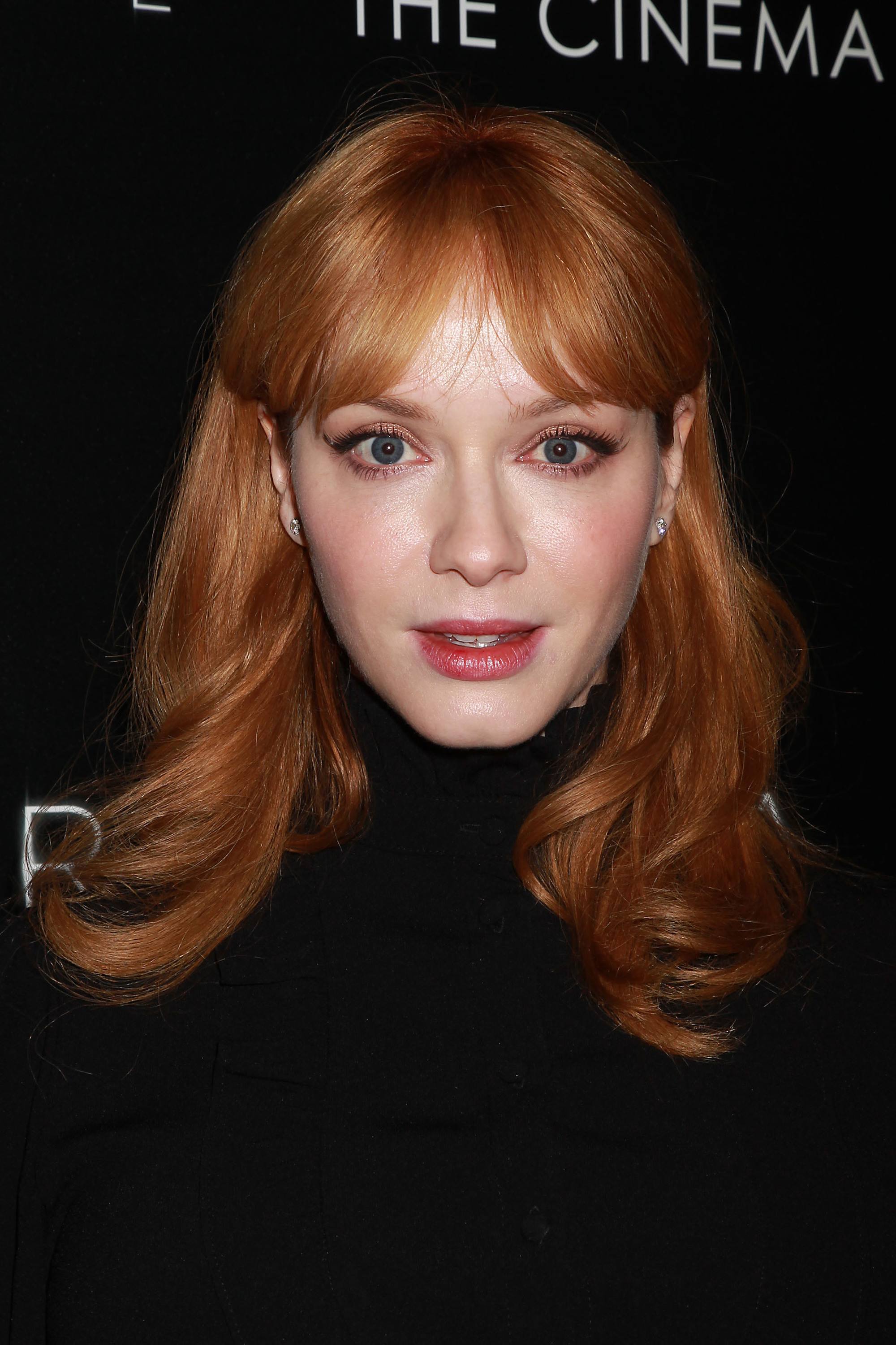 christina hendricks with curly red hair with a split fringe