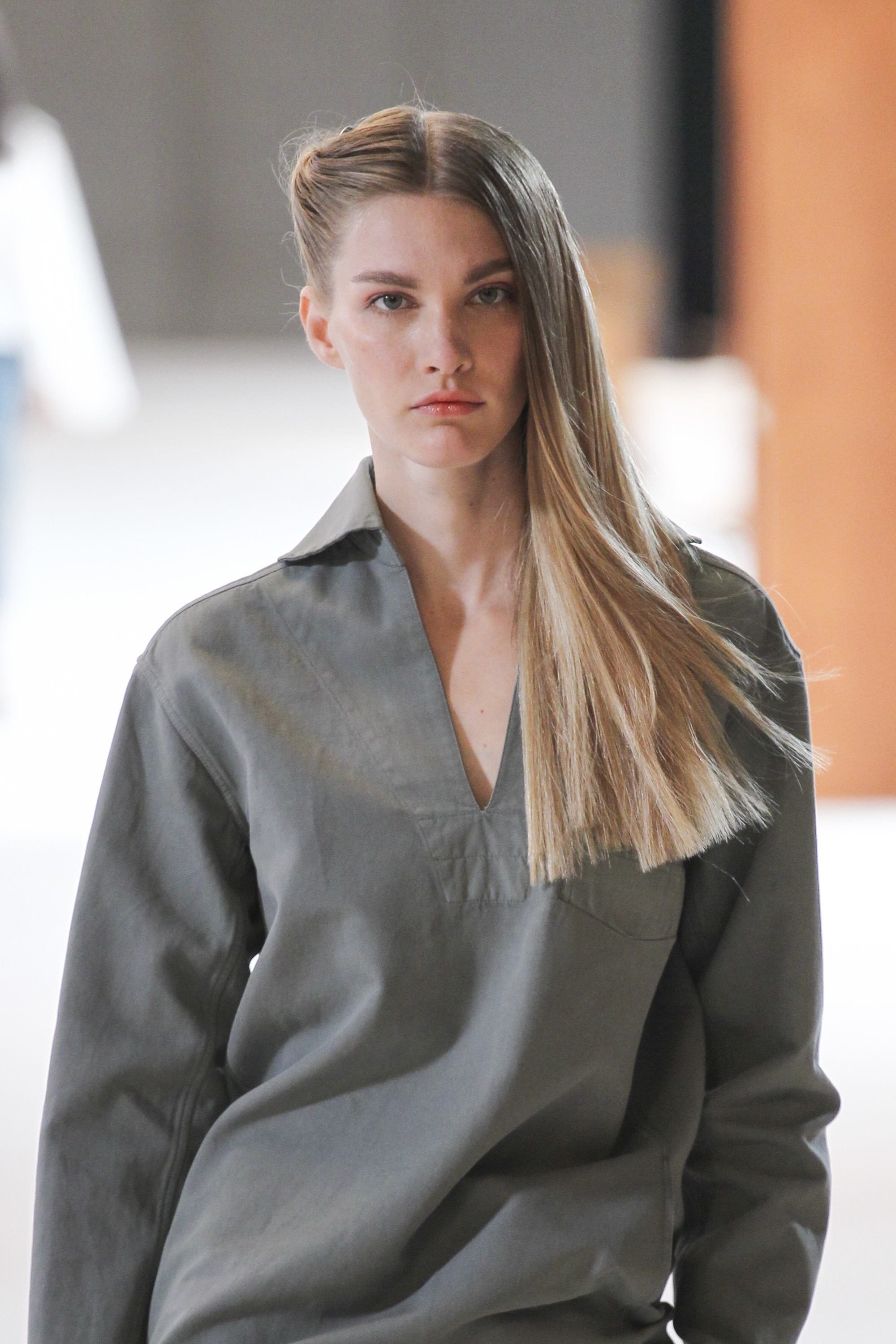 model with straight light brown hair with a twisted detail