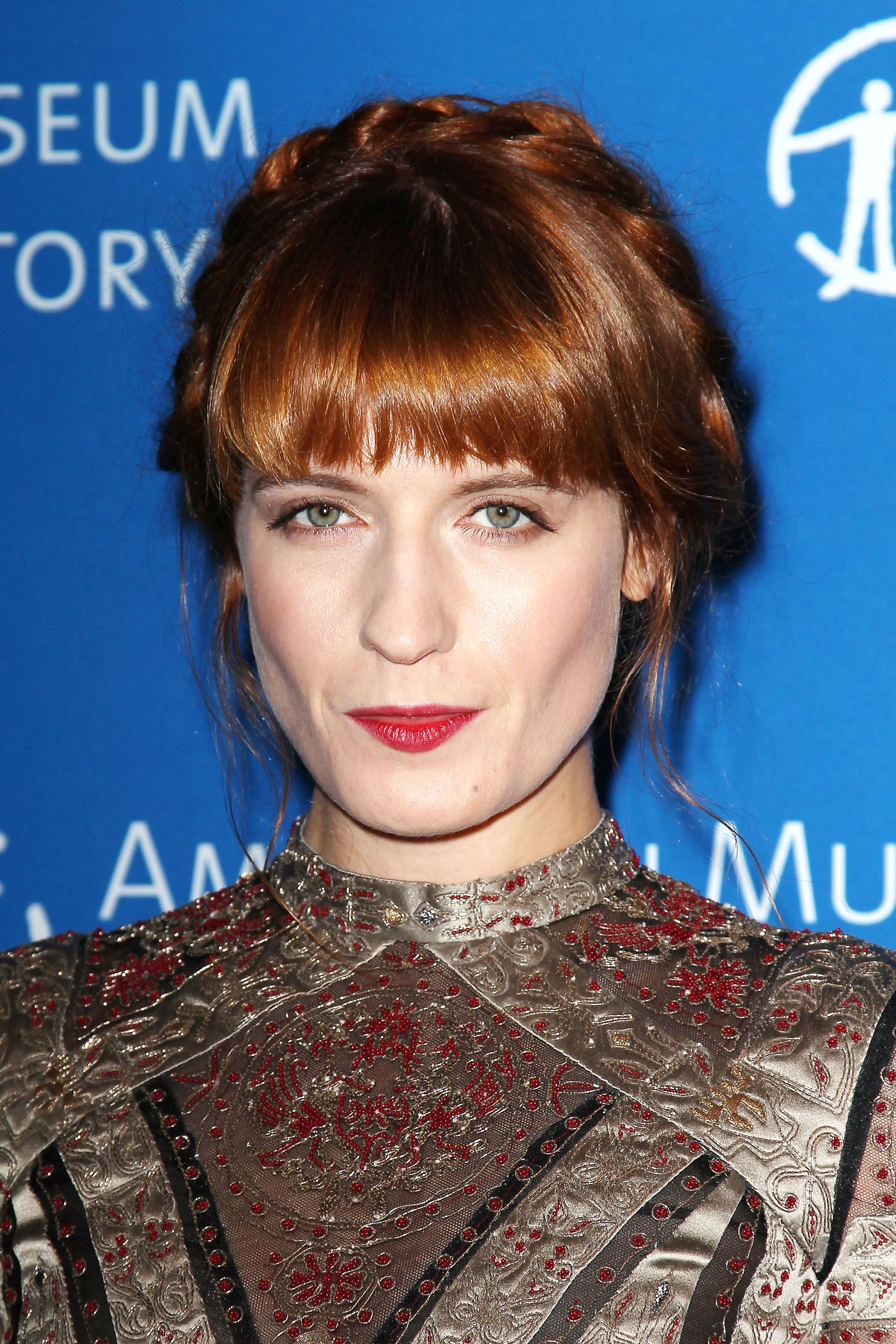 singer florence welch with her auburn hair in a pretty halo braid
