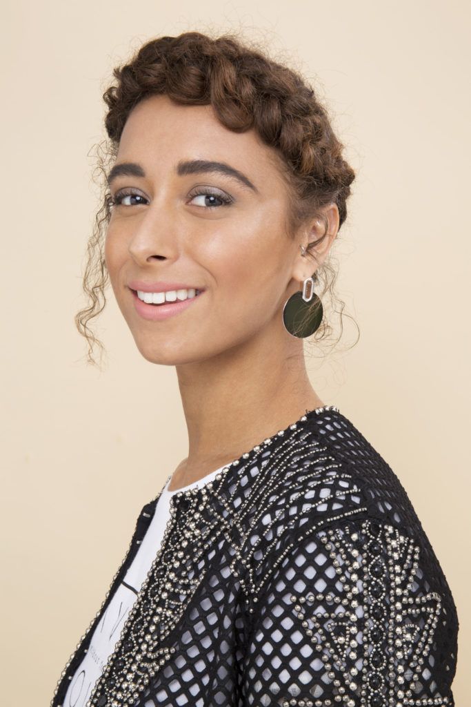 woman with natural curly hair in a halo braid