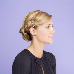 Blonde hair in a side updo finished with silver jewelled accessories