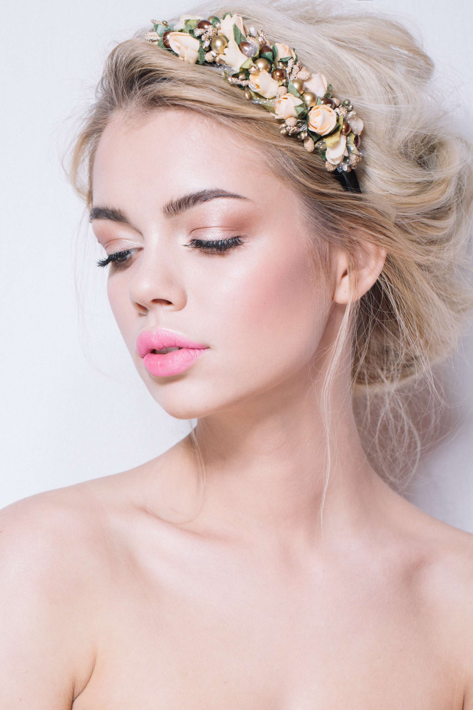 Blonde hair in loose updo finished with floral headband