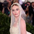 close up shot of kate bosworth with finger waves bun hairstyle and pearl veil hair accessory, wearing all white and posing on the 2018 met gala red carpet