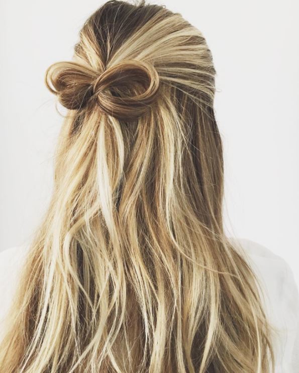 Long blonde wavy hair in bow half,up-half,down hairstyle