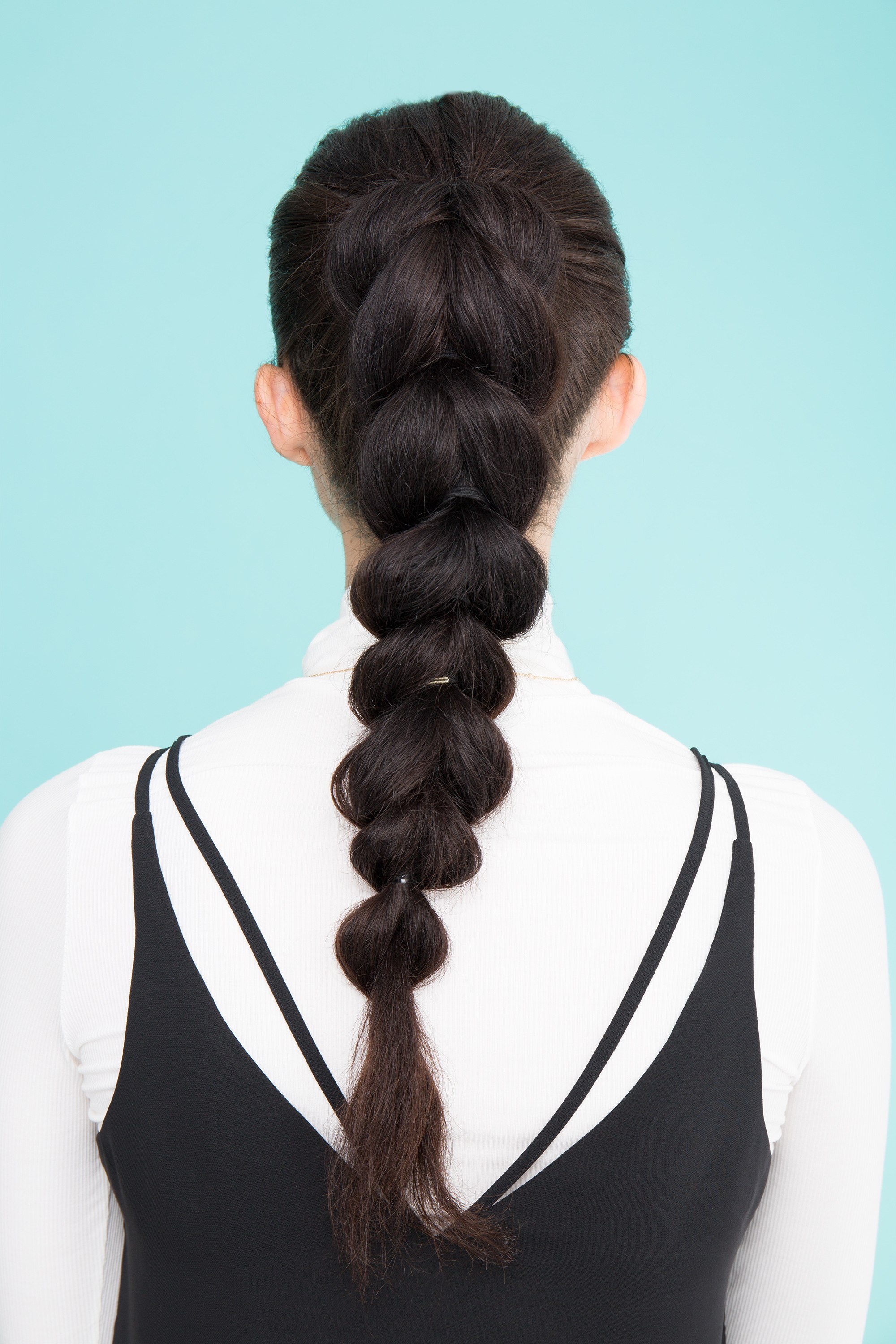 Pancaked braid ponytail on long dark brown hair