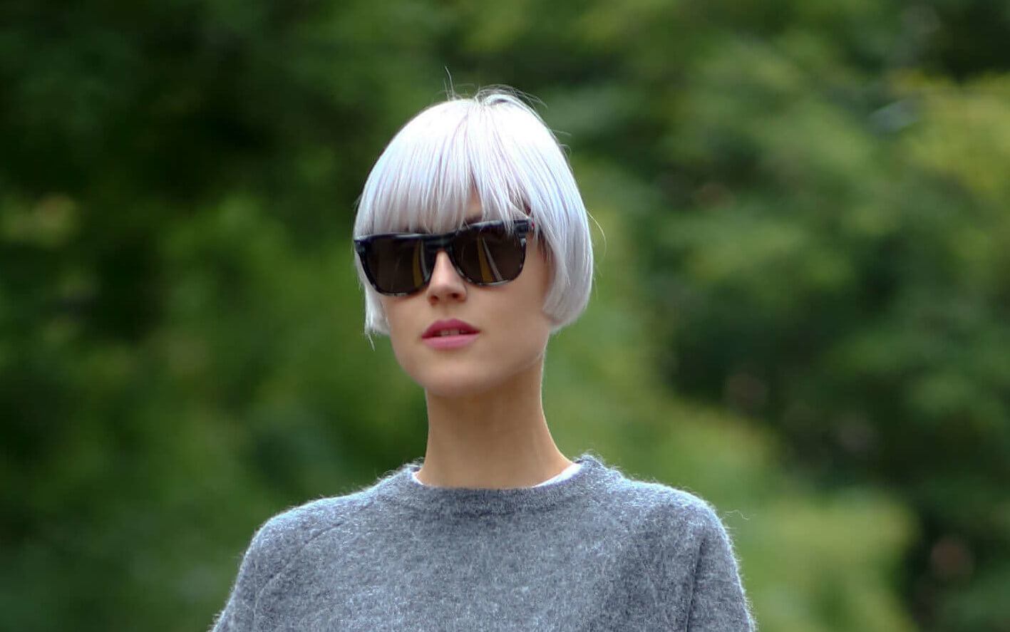 woman wearing a grey jumper with a short pewter coloured bob