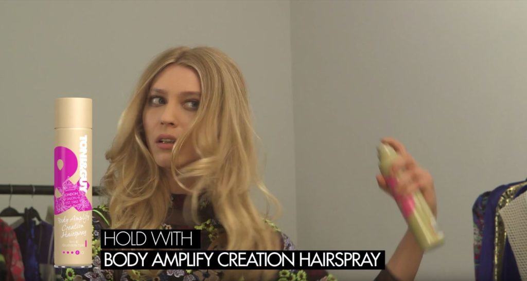Toni & Guy The Marla - blonde model adding product to long hair