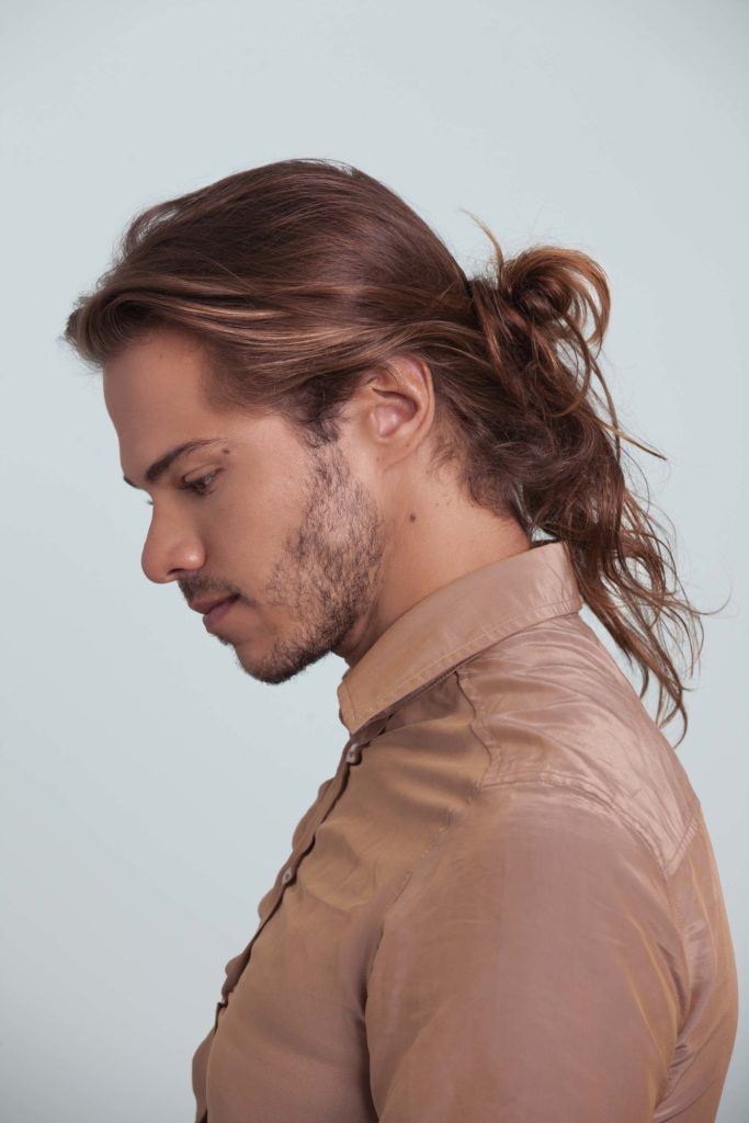 Man bun tutorial guy with messy man bun looking down side profile picture