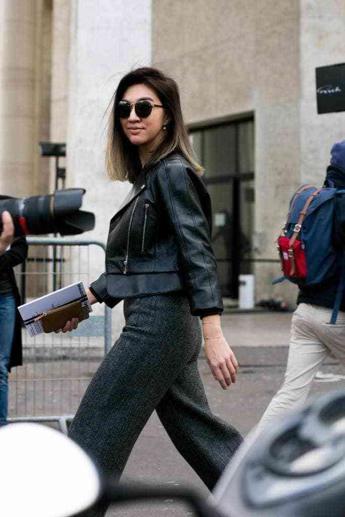 Short ombre hair: Woman with long bob brown hair with blonde ombre finish walking down the street.