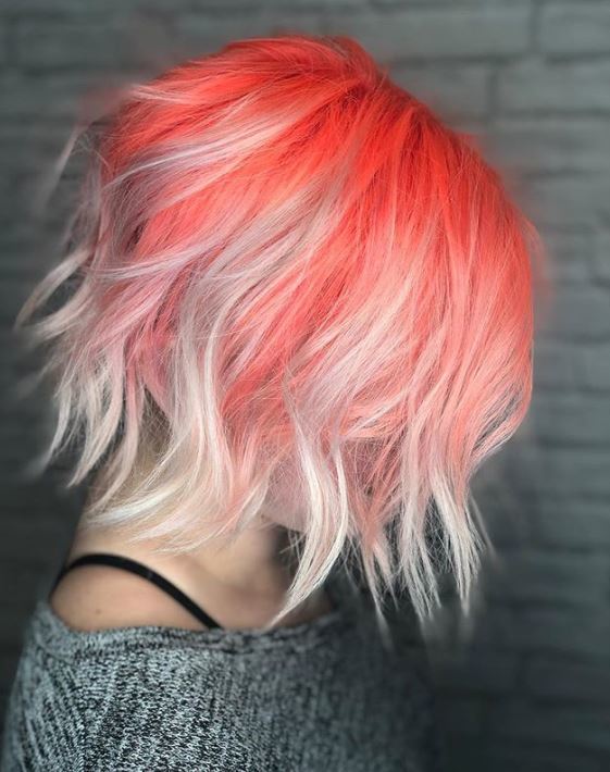 Short ombre hair: Woman with short wavy bob with coral roots and silver ennds ombre colour.