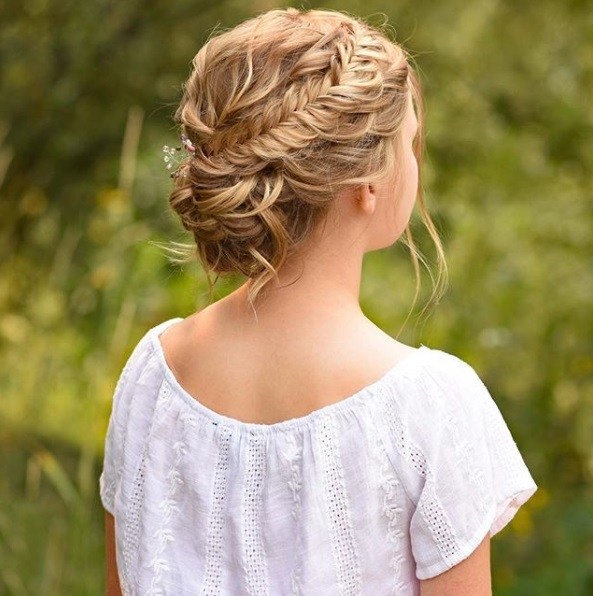 blonde with a fishtail crown braid into a bun
