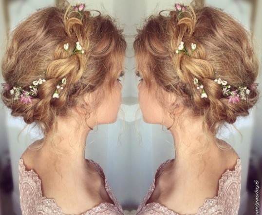 blonde woman with milkmaid braid with flowers in it