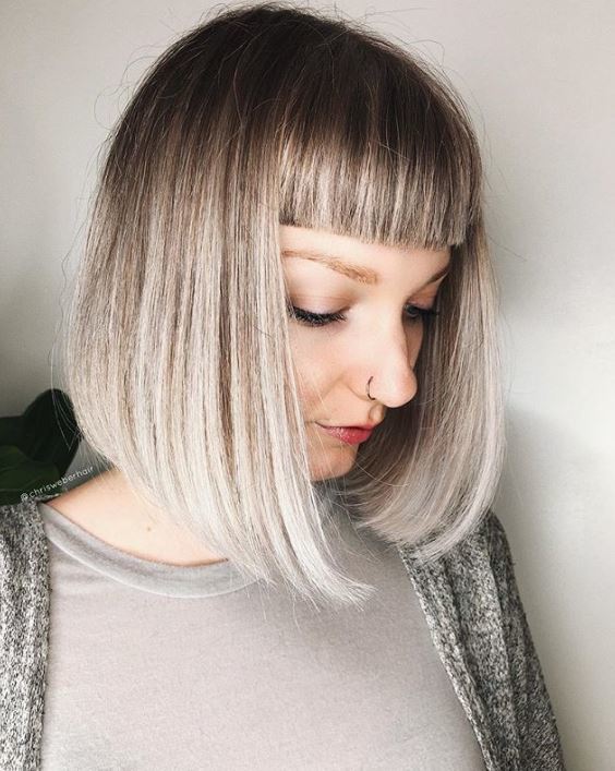 Short ombre hair: Woman with straight grey ombre hair with micro bangs