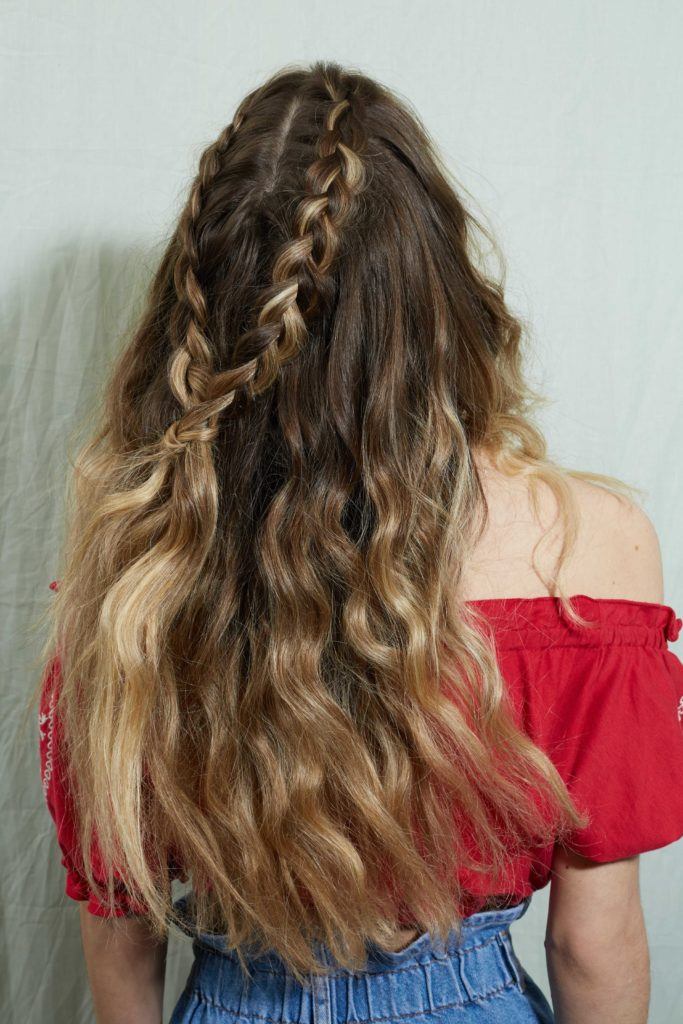 Woman with wavy brunette ombre hair in a half-up braid