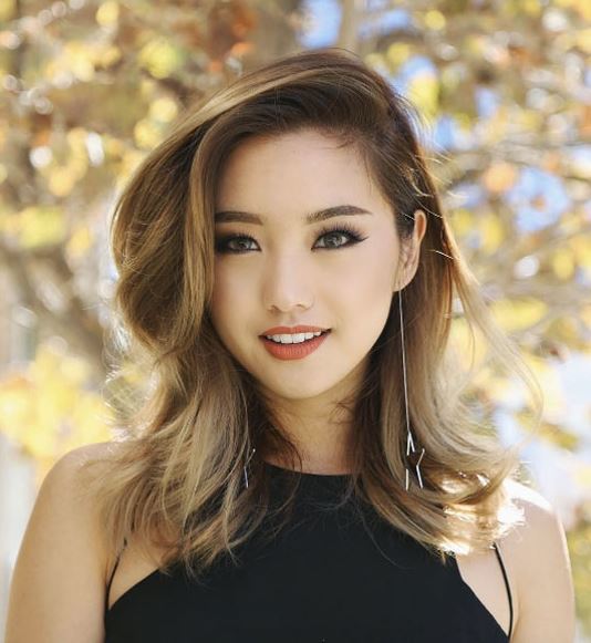 Face shapes - model with mid-length brown to blonde balayage hair swept to the side