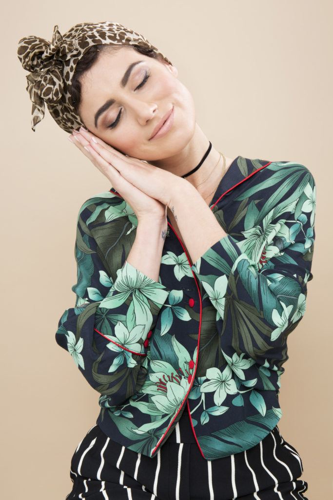 Pin curls tutorial: Brunette model with silk scarf leaving her pin curls to set