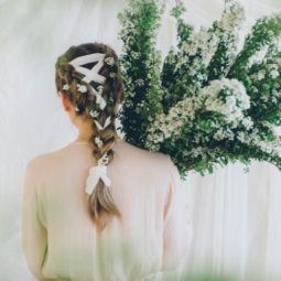 shot of model with braids with ribbons holding flowers