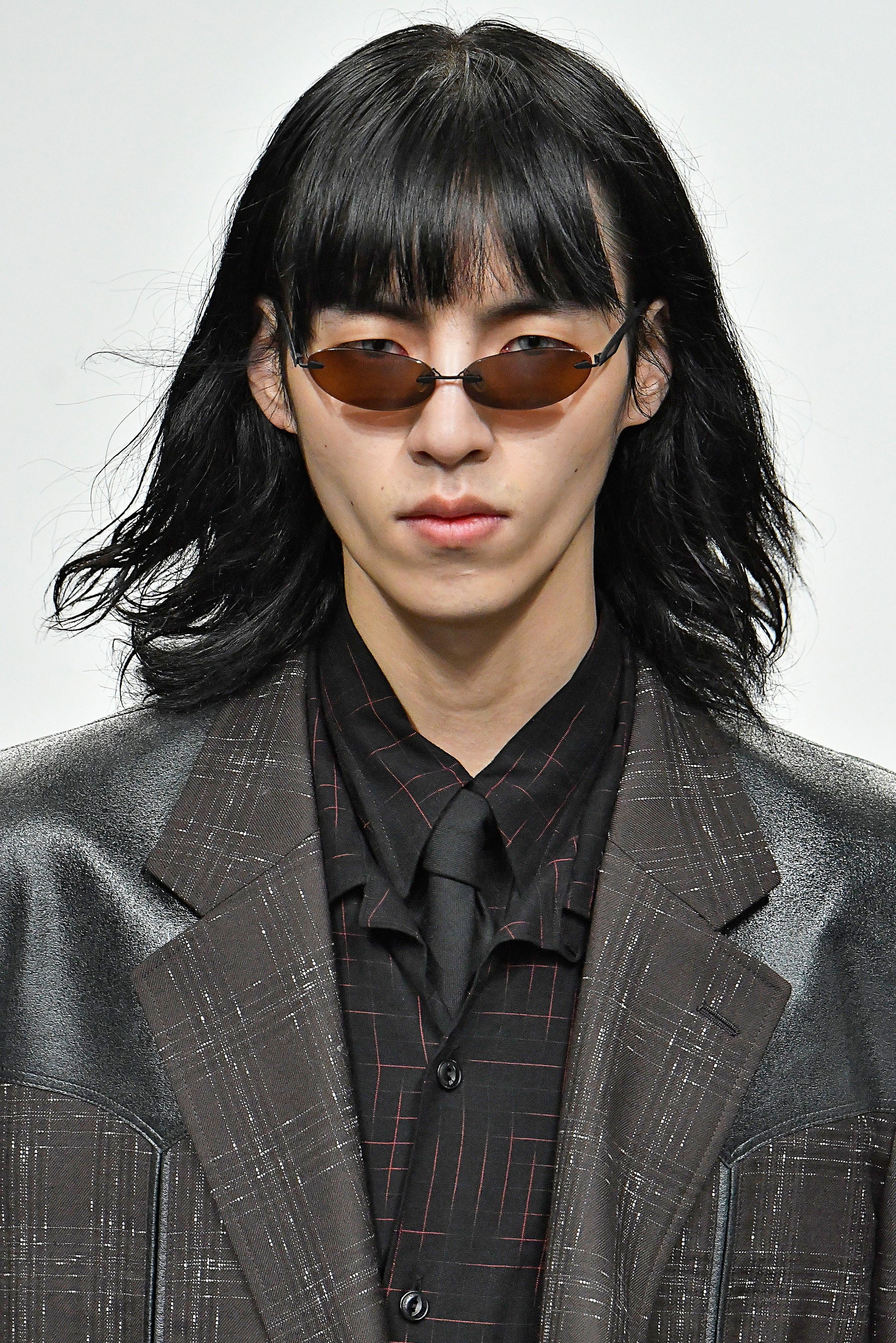 male model at john lawrence sullivan lfwm aw18 show with dark shoulder length hair with a fringe