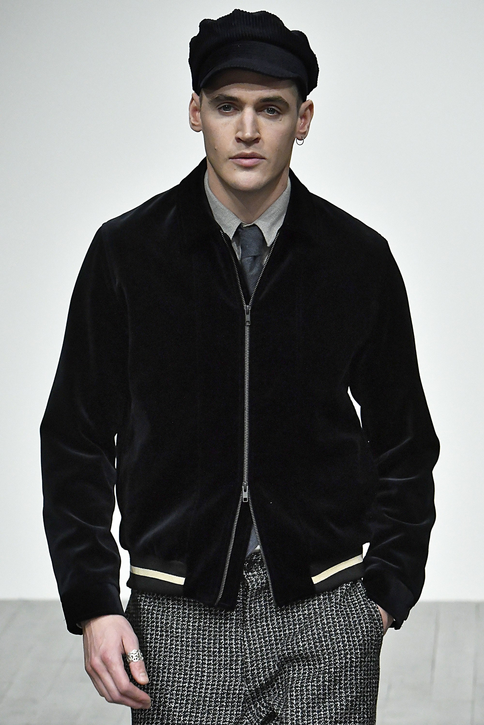 male model at the oliver spencer aw18 lfwm show wearing a black baker boy hat