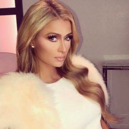 paris hilton with long blonde blow out hairstyle wearing white dress
