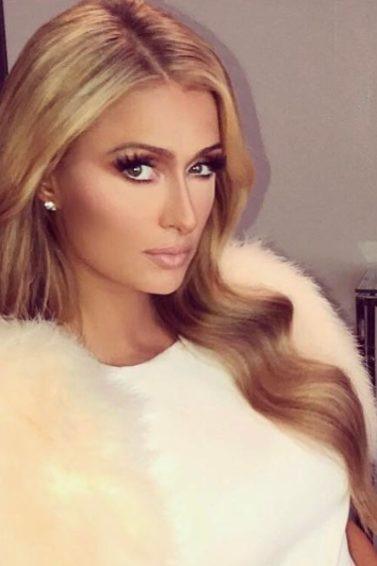 paris hilton with long blonde blow out hairstyle wearing white dress