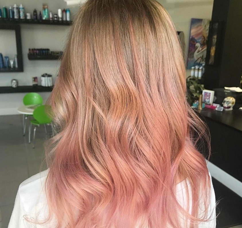 pink champagne balyage hair on woman at a salon