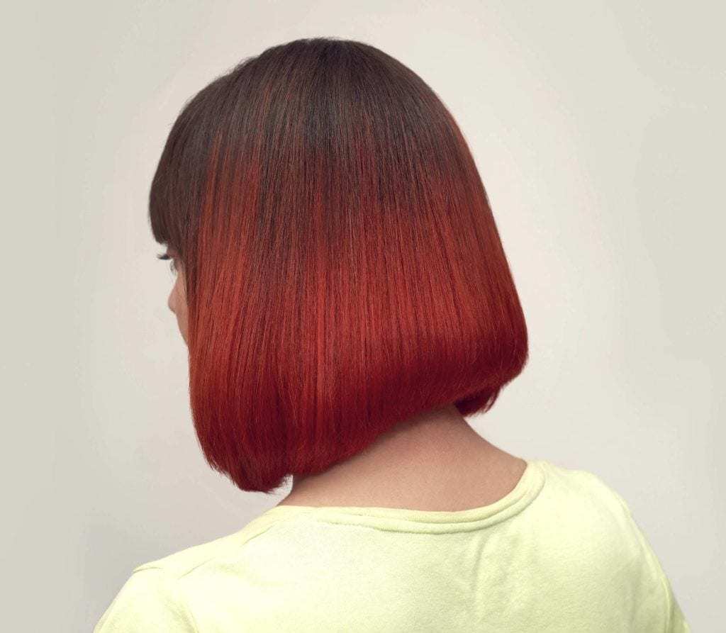 Short ombre hair: Woman with straight brown cherry ombre hair with a fringe.