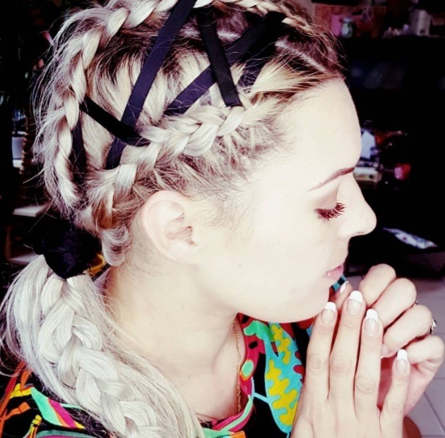 woman with corset ribbon braids weaved into a braided low ponytail