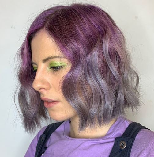 Short ombre hair: Woman with wavy purple metallic ombre bob.