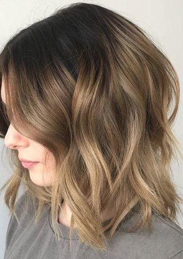 Short ombre hair: Woman with long bob wavy brown soft ombre hair.
