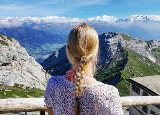 woman with a blonde braid with flowers in