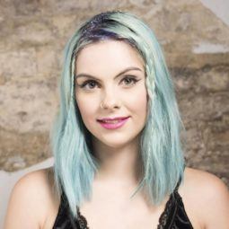 Sophie Hannah Richardson with hidden braids and glitter parting on her blue-green hair