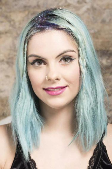Sophie Hannah Richardson with hidden braids and glitter parting on her blue-green hair