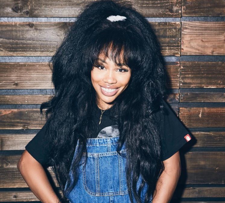 SZA - half-up, half-down hairstyle with full bangs