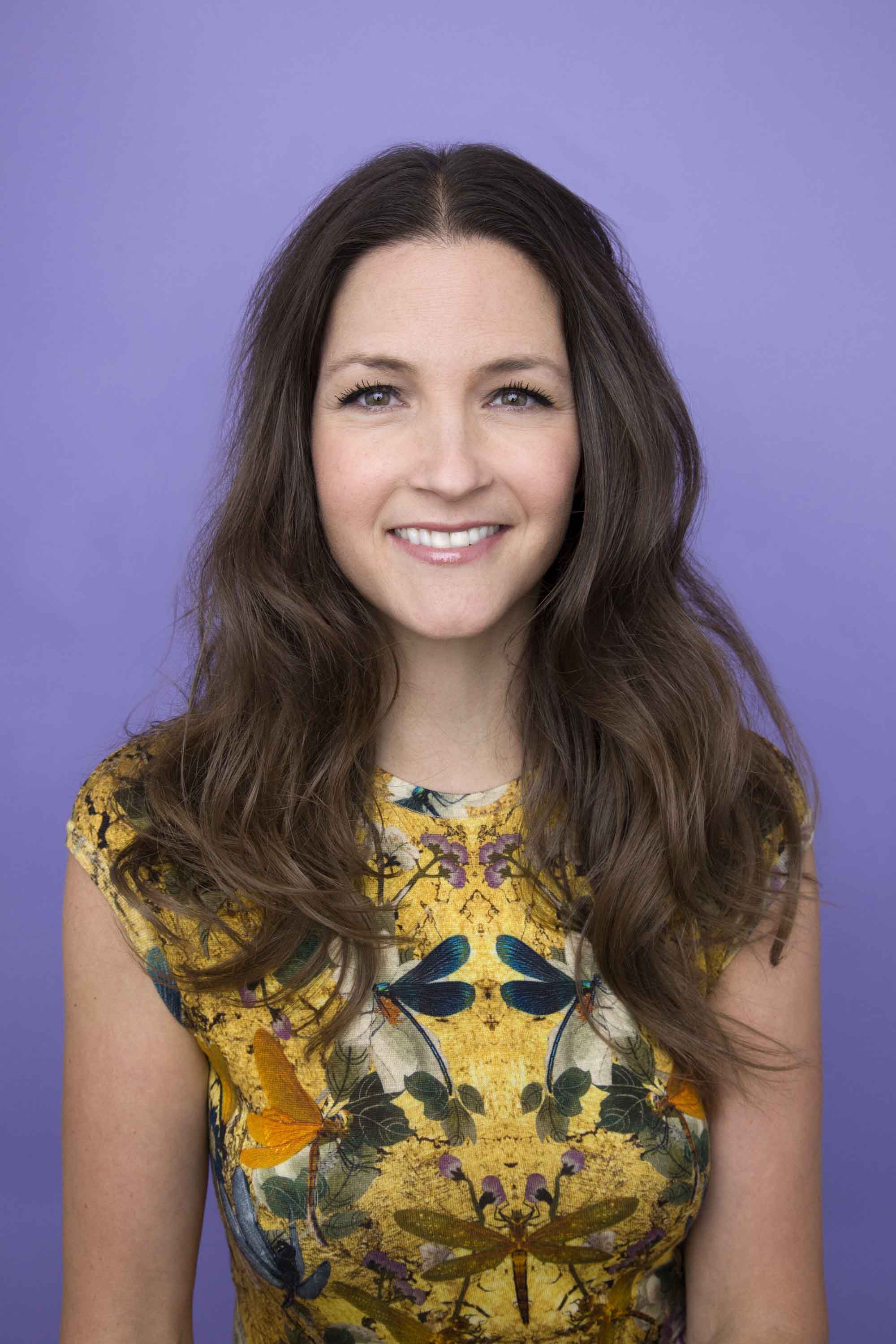 woman with brown medium length hair styled with big loose waves in studio