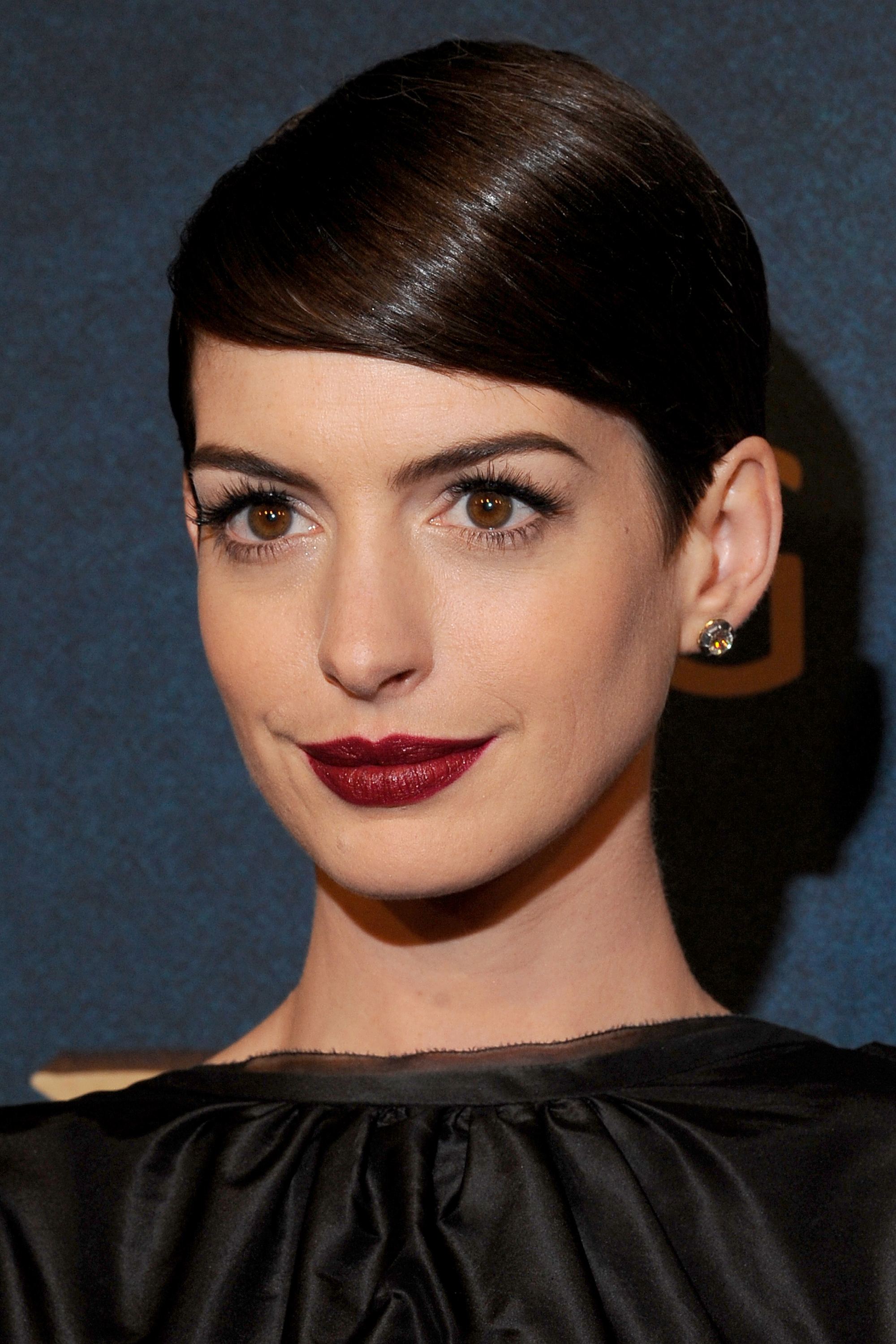 anne hathaway dark brown short pixie hair styled into sleek side fringe
