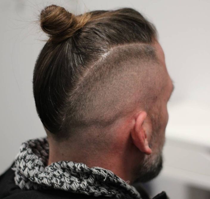 back shot of male top knot with bald fade hairstyle