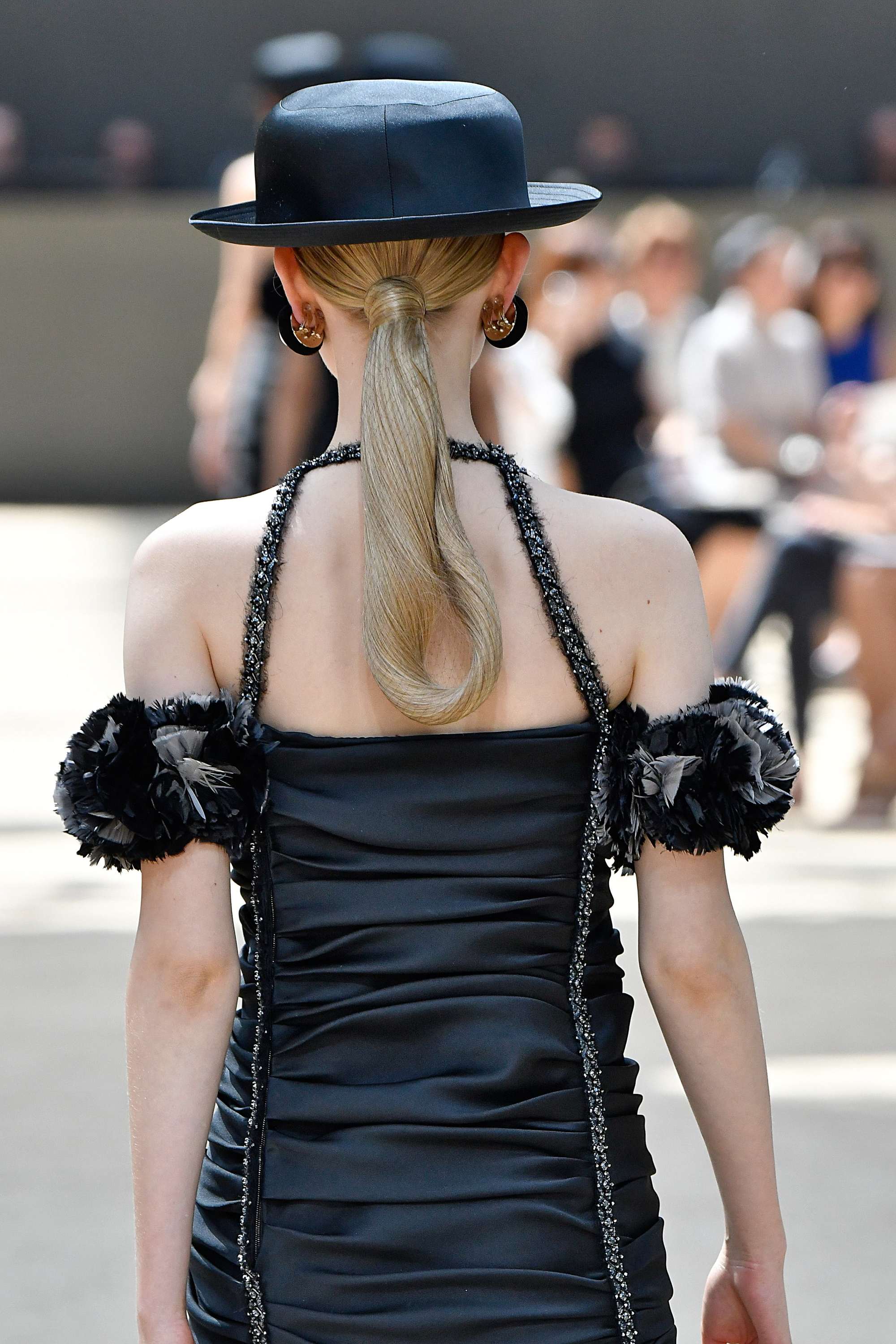 backshot of model with a netted low ponytail on the chanel paris haute couture runway 2017