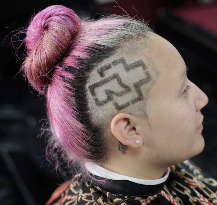 colourful men's top knot style fashioned into a bun and featuring patterned shave design