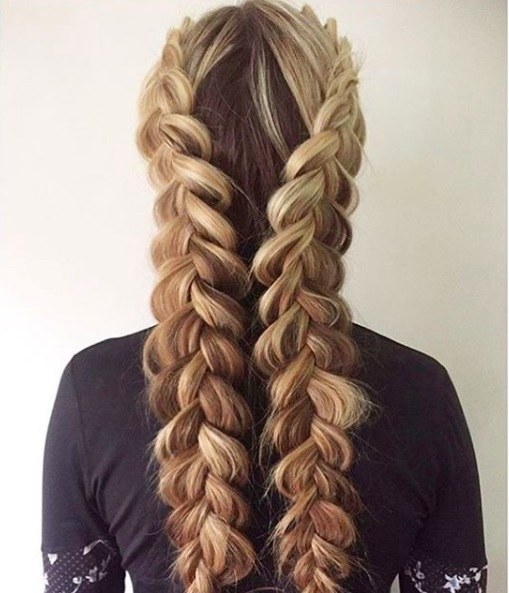 back view of a woman with long blond hair in a double dutch braid style