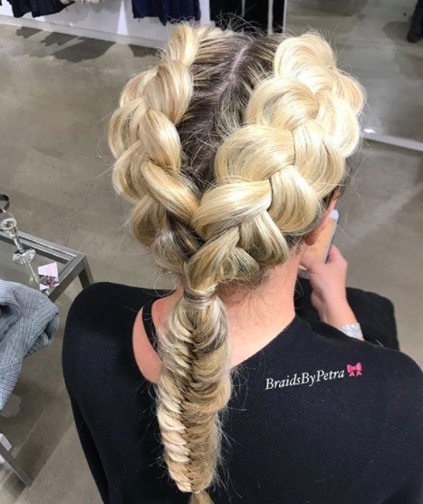 back view of a woman with double Dutch braids, blonde hair and a fishtail braid