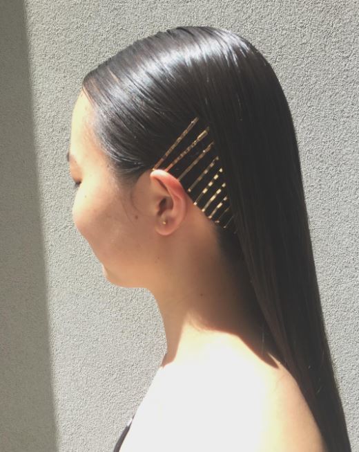 Metal hair accessories - long dark smooth straight hair with side covered in hair slides
