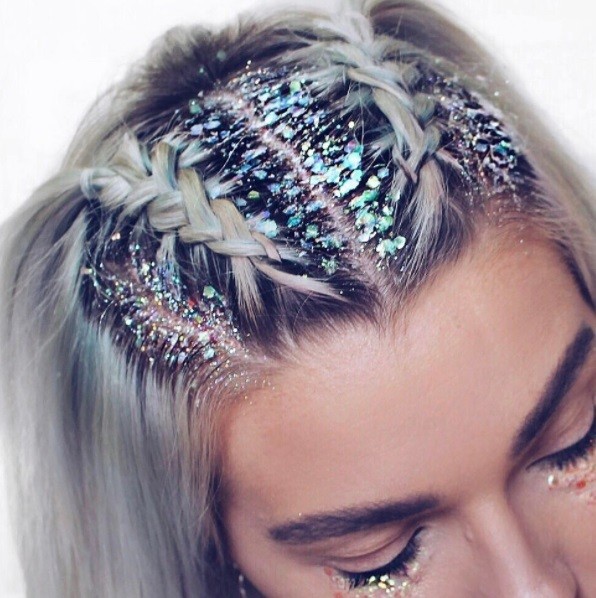 blonde woman with her hair in braids with glitter roots