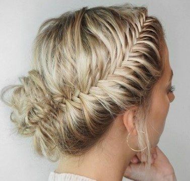 blonde woman with her hair in a french fishtail updo