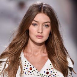 model gigi hadid on the runway with her signature long wavy hair