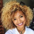 ownbyfemme with sunkissed blonde afro hair smilling Instagram