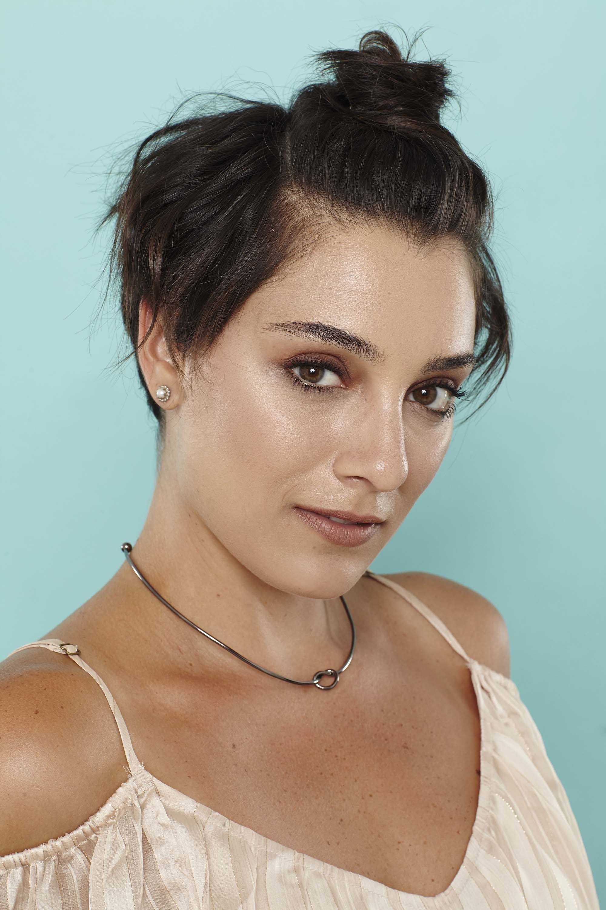 Short summer hairstyles - dark brown pixie crop with top bun