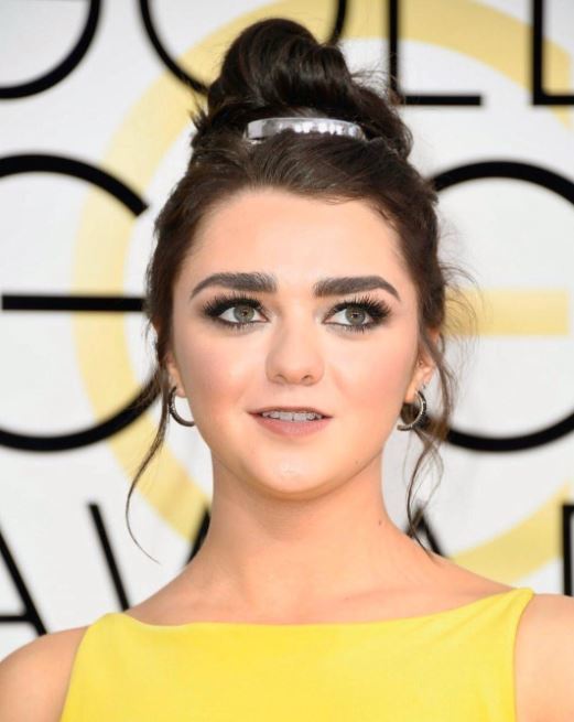 Short summer hairstyles - Maisie Williams with messy bun and metal accessory